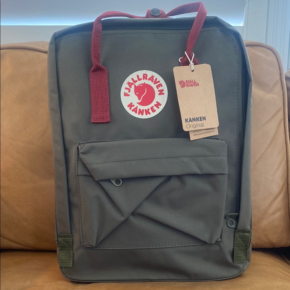 Army green classic sized Fjallraven backpack with red straps